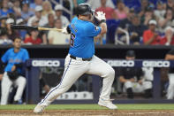 Miami Marlins' Jake Burger hits a single during the third inning of a baseball game against the Los Angeles Angels, Wednesday, April 3, 2024, in Miami. (AP Photo/Marta Lavandier)
