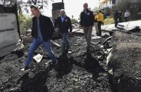 From left, California Governor Gavin Newsom, L.A. City Councilman Mike Bonin, and L.A. City Mayor Eric Garcetti tour a burned home along Tigertail Road in Brentwood, Calif., Tuesday Oct. 29, 2019. (Wally Skalij/Los Angeles Times via AP, Pool)