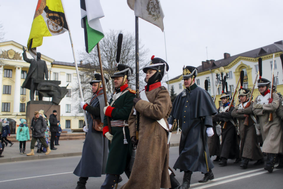 Men dressed as 1812-era Russian and French soldiers march to take part in a re-enactment of the battle in the town of Borisov, 70 km (44 miles) east of Minsk, Belarus, Saturday, Nov. 23, 2019, to mark the 207th anniversary of the Berezina battle during Napoleon's army retreat from Russia. (AP Photo/Sergei Grits)