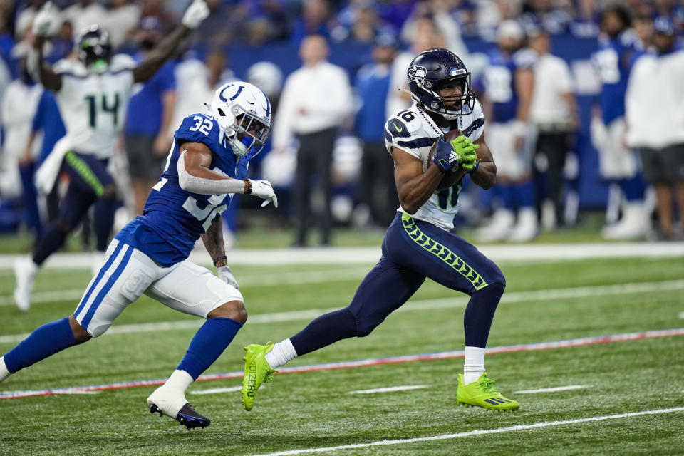 Seattle Seahawks wide receiver Tyler Lockett (16) makes catch in front of Indianapolis Colts safety Julian Blackmon (32) on his way to a touchdown during the first half of an NFL football game in Indianapolis, Sunday, Sept. 12, 2021. (AP Photo/AJ Mast)