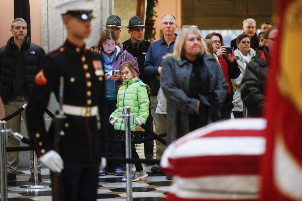 Mourners arrive to view the casket of John Glenn, Friday, Dec. 16, 2016, in Columbus, Ohio. Glenn's home state and the nation began saying goodbye to the famed astronaut who died last week at the age of 95. (AP Photo/John Minchillo)