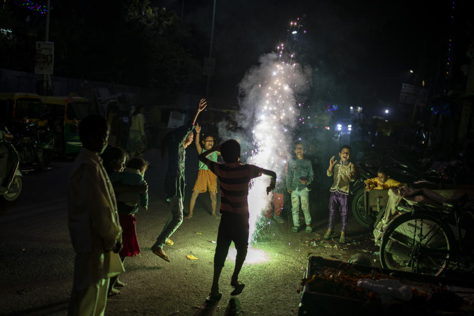 Children play with firecrackers during Diwali celebrations in New Delhi, India, Thursday, Nov. 4, 2021. Diwali, the festival of lights, is one of Hinduism's most important festivals dedicated to the worship of Lakshmi, the Hindu goddess of wealth. (AP Photo/Altaf Qadri)