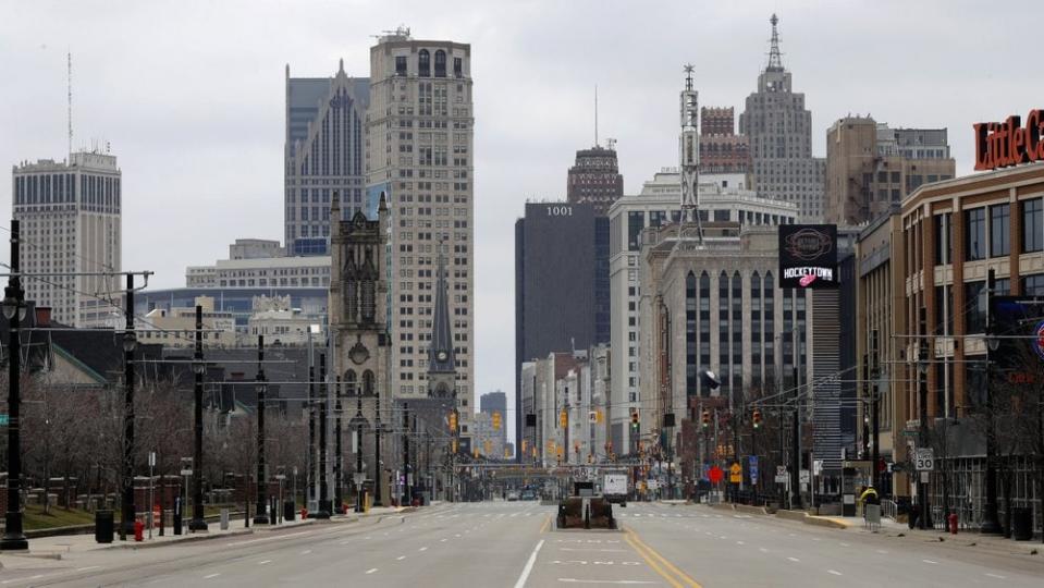 In this March 24, 2020 file photo, Woodward Avenue is shown nearly empty in Detroit. Before the coronavirus showed up, downtown Detroit was returning to its roots as a vibrant city center, motoring away from its past as the model of urban ruin. (AP Photo/Paul Sancya)