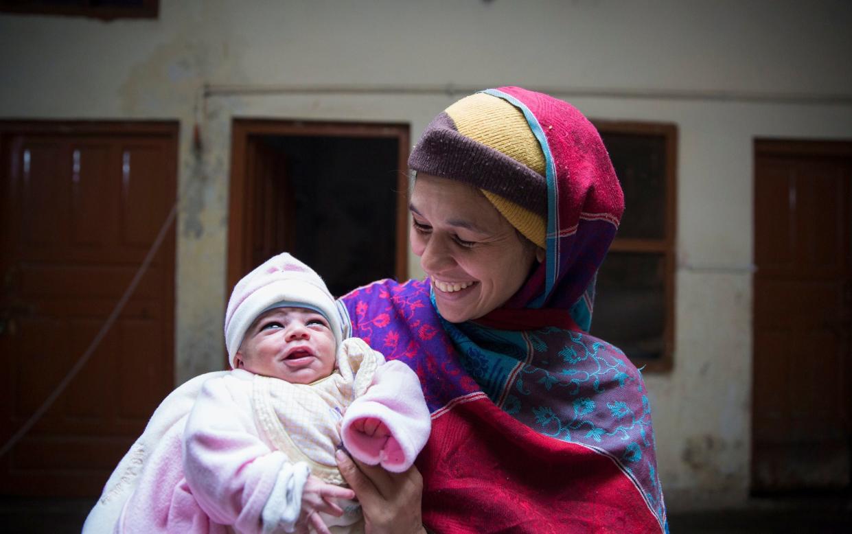 Sobia Sajid along with her newborn at home, nine days after she suffered from postpartum haemorrhaging and was given tranexamic acid - Saiyna Bashir / Wellcome Trust