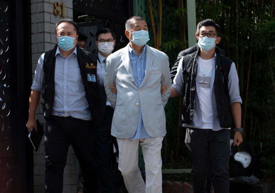 <p>A file image of Hong Kong media tycoon Jimmy Lai being taken away after his arrest in August 2020</p> (EPA)