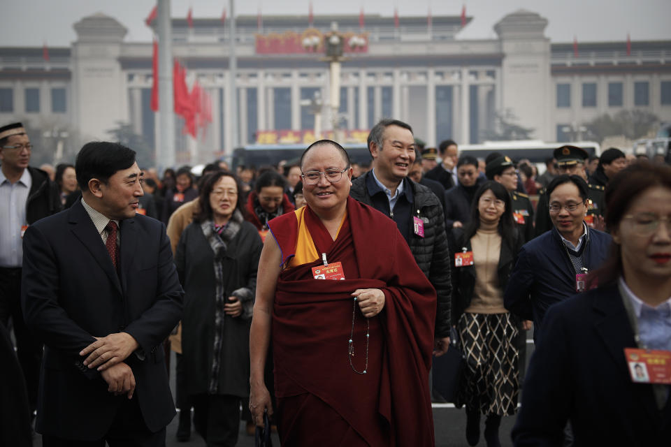 A Tibetan monk, a delegate to the Chinese People's Political Consultative Conference (CPPCC), arrives with other delegates to attend a plenary session of the CPPCC at the Great Hall of the People in Beijing, Sunday, March 10, 2019. China is defending its often-criticized policies toward Tibet 60 years after the Dalai Lama fled abroad amid an uprising against Chinese rule. The official Xinhua News Agency says economic growth, increases in lifespan and better education refute the claims of critics. (AP Photo/Andy Wong)