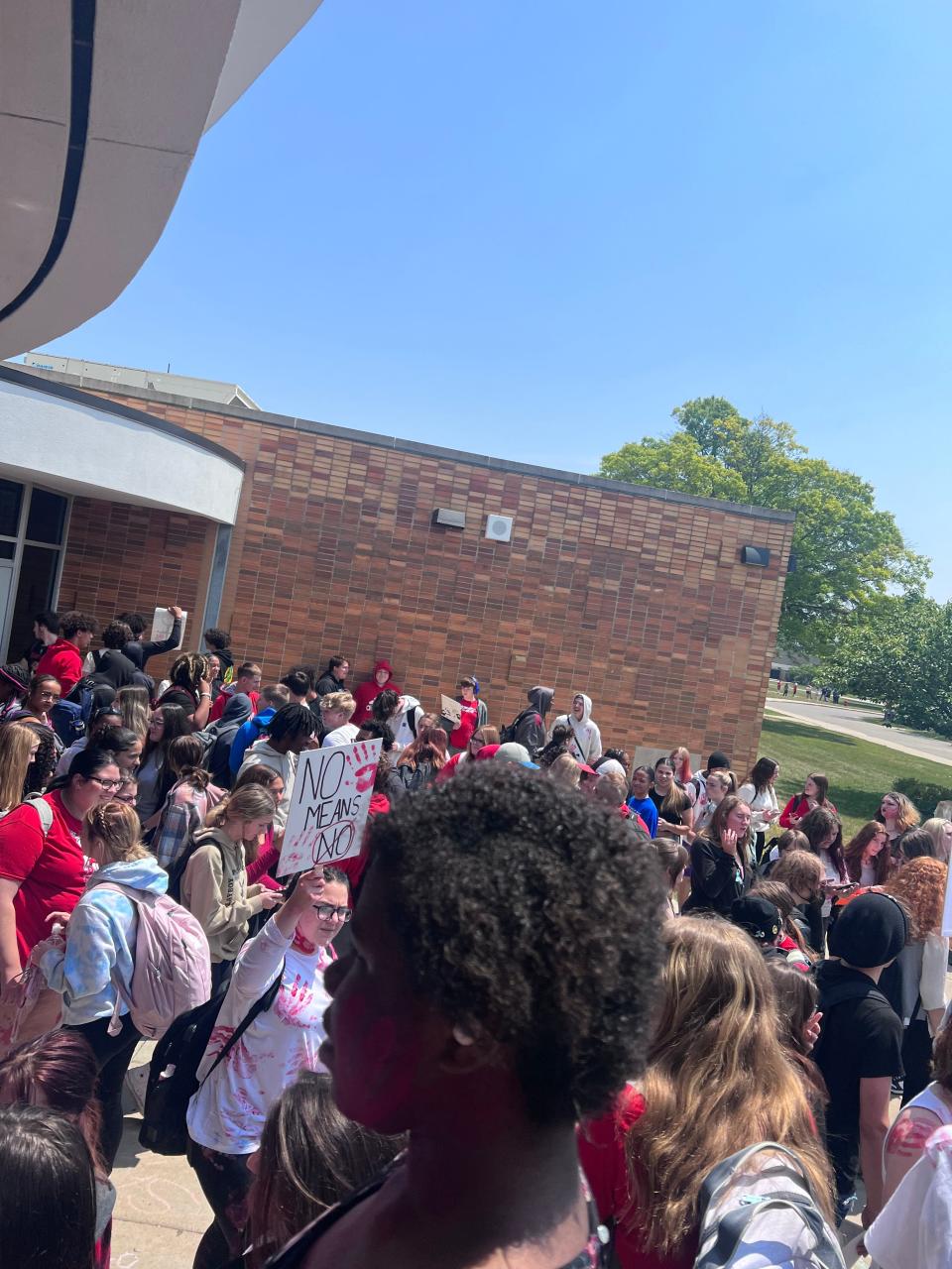 Students at Port Huron High School participating in a walkout that is aimed at sexual assault reform on June 9, 2023.