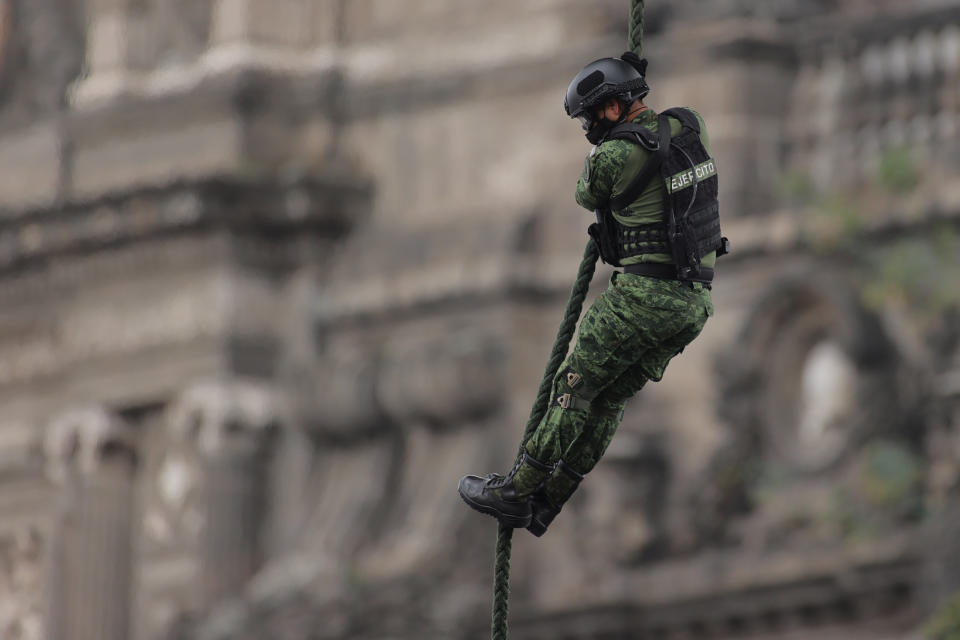 VARIOUS CITIES, MEXICO - SEPTEMBER 16: A Mexican Air Force soldier performs a ceremonial flight during the Independence Day military parade at Zocalo Square on September 16, 2020 in Various Cities, Mexico. This year El Zocalo remains closed for general public due to coronavirus restrictions. Every September 16 Mexico celebrates the beginning of the revolution uprising of 1810. (Photo by Hector Vivas/Getty Images)