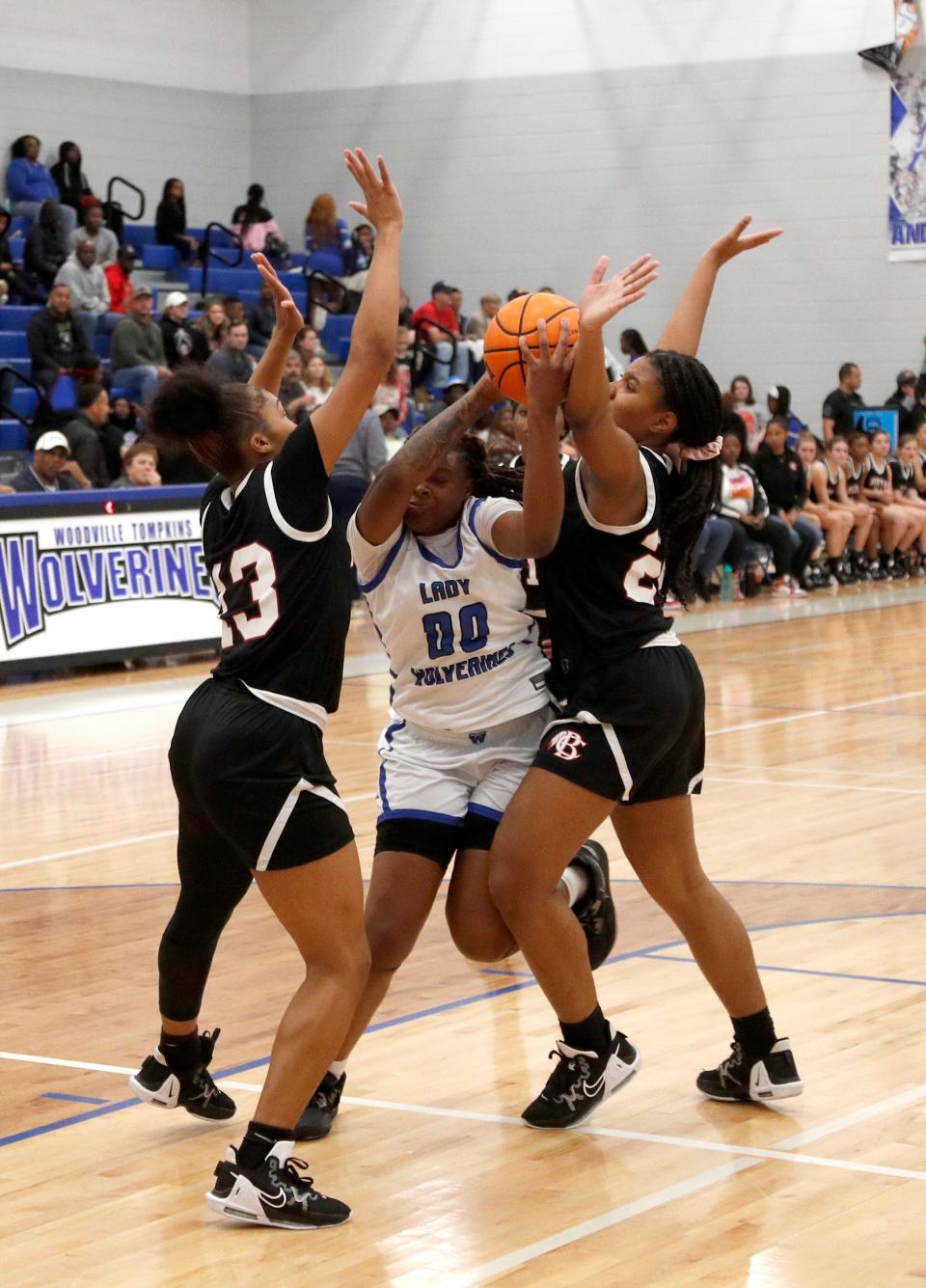 Woodville-Tompkins' Janiyah Heyward splits a Bryan County double team by Ashanti Brown and Soniya Whitaker during the Region 3A Division 1 title game.