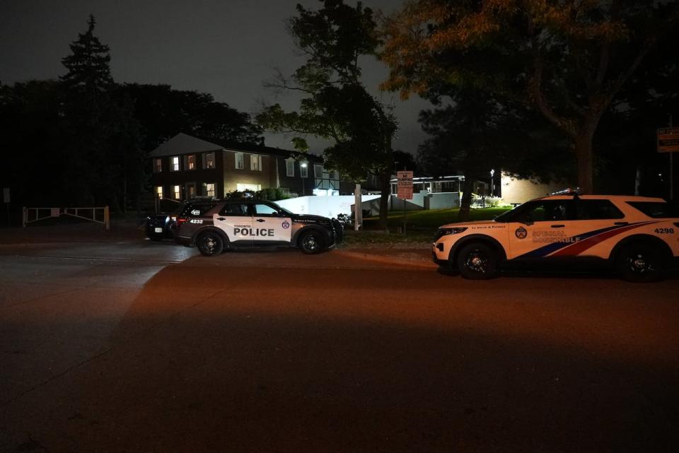 Toronto police vehicles near the scene of the stabbing.