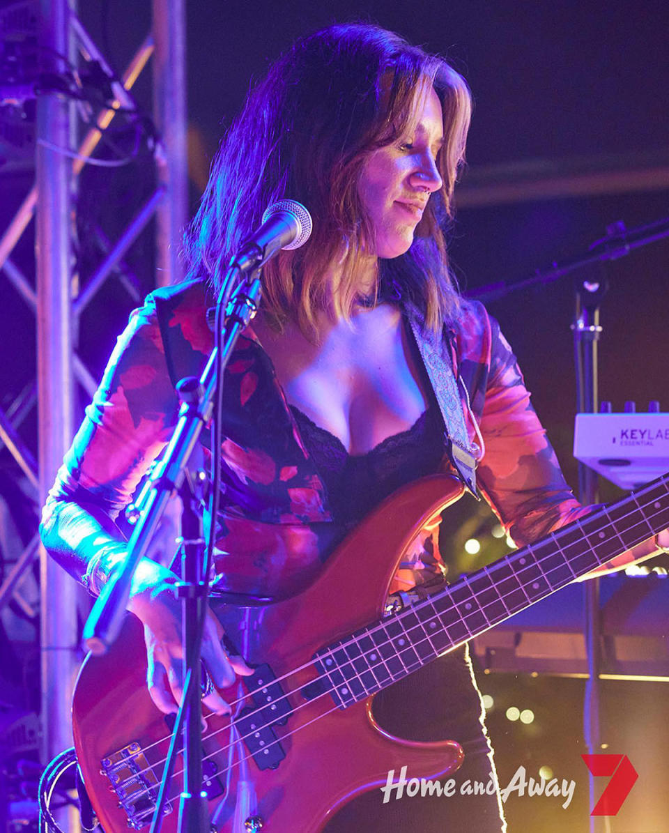 Stephanie Panozzo as her character Eden Fowler playing the bass guitar