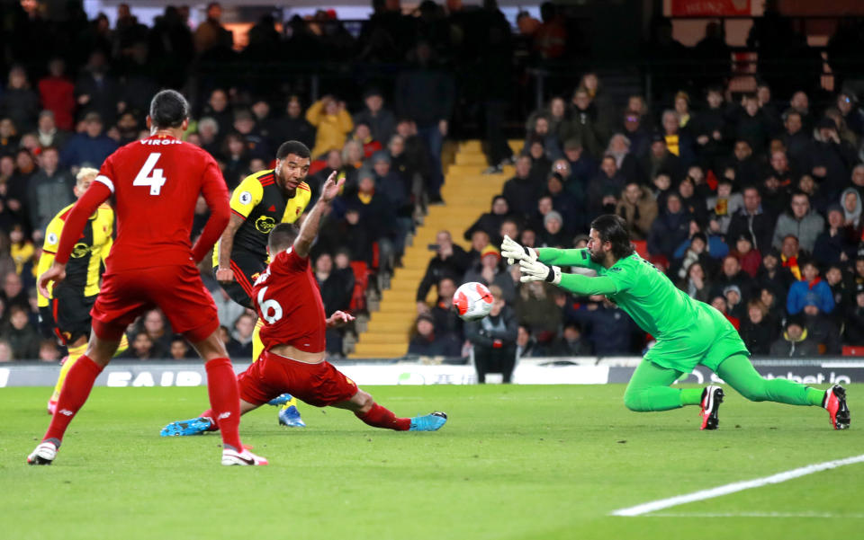 Liverpool goalkeeper Alisson (right) saves a shot from Watford's Troy Deeney (third left) during the Premier League match at Vicarage Road, Watford. (Photo by Adam Davy/PA Images via Getty Images)