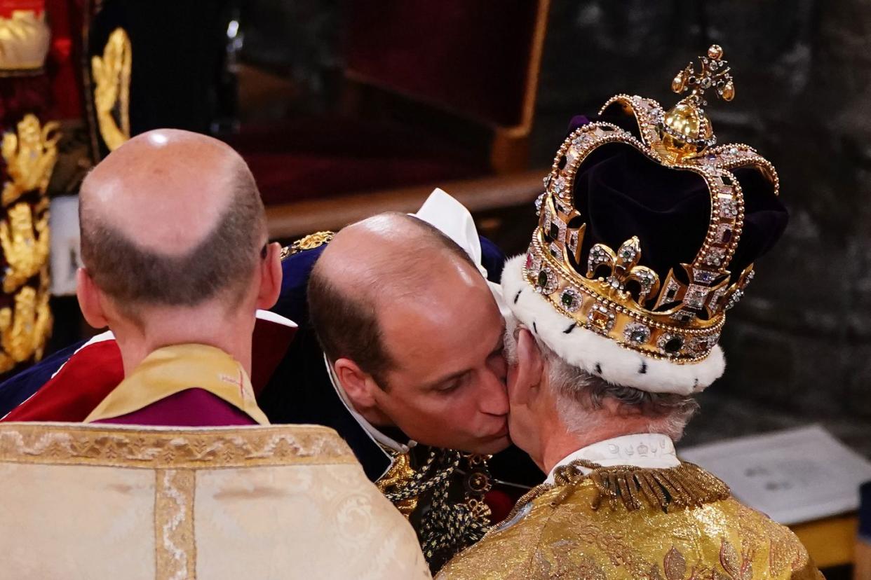 london, england may 06 prince william, prince of wales kisses his father, king charles iii, wearing st edwards crown, during the kings coronation ceremony inside westminster abbey on may 6, 2023 in london, england the coronation of charles iii and his wife, camilla, as king and queen of the united kingdom of great britain and northern ireland, and the other commonwealth realms takes place at westminster abbey today charles acceded to the throne on 8 september 2022, upon the death of his mother, elizabeth ii photo by yui mok wpa poolgetty images