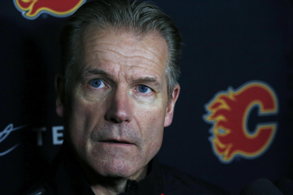 Calgary Flames associate coach Geoff Ward addresses the media following a NHL hockey practice Tuesday, Nov. 26, 2019, in Buffalo, N.Y. Flames general manager Brad Treliving says coach Bill Peters remains on the staff but wasn’t certain whether he’d be behind the bench for the next game. The team and the NHL are both investigating an allegation the Peters directed racial slurs at a player 10 years ago when the two were in the minors. Akim Aliu, a Nigerian-born player, says Peters “dropped the N bomb several times” in a dressing room during his rookie year.(AP Photo/Jeffrey T. Barnes)