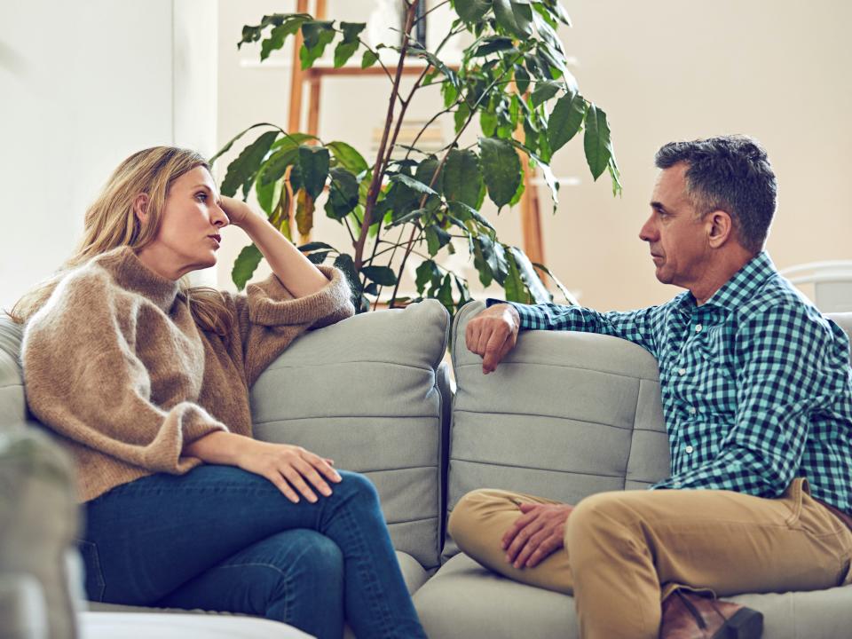Couple talking on couch older man woman divorce unhappy at home