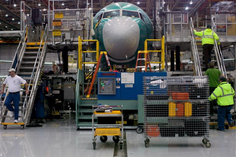 Boeing employees march up and down stairs entering and exiting Boeing 737 MAX during a media tour of the Boeing 737 MAX at the Boeing plant in Renton, Washington December 7, 2015. REUTERS/Matt Mills McKnight