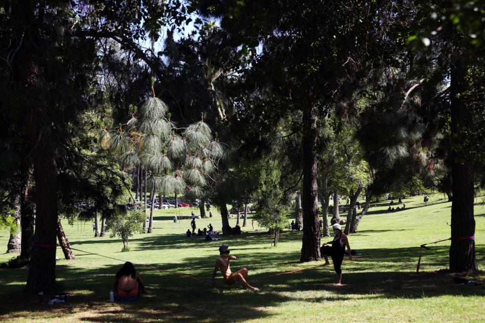 Visitors enjoy the shade on a hot day in Elysian Park in Los Angeles.