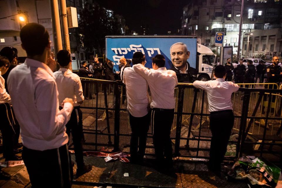 A poster showing Likud party leader Benjamin Netanyahu after a 2022 campaign event in Bnei Brak, Israel. <a href="https://www.gettyimages.com/detail/news-photo/supporters-look-at-the-likud-party-campaign-modified-truck-news-photo/1244330524?phrase=bnei%20brak&adppopup=true" rel="nofollow noopener" target="_blank" data-ylk="slk:Amir Levy/Getty Images;elm:context_link;itc:0;sec:content-canvas" class="link ">Amir Levy/Getty Images</a>