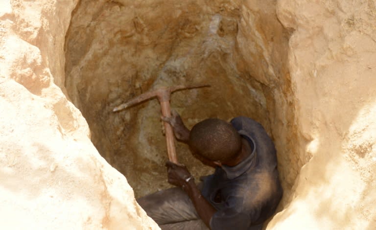 A man digs in a hole as families flock to Kafa-Koira after getting wind of Niger's goldrush