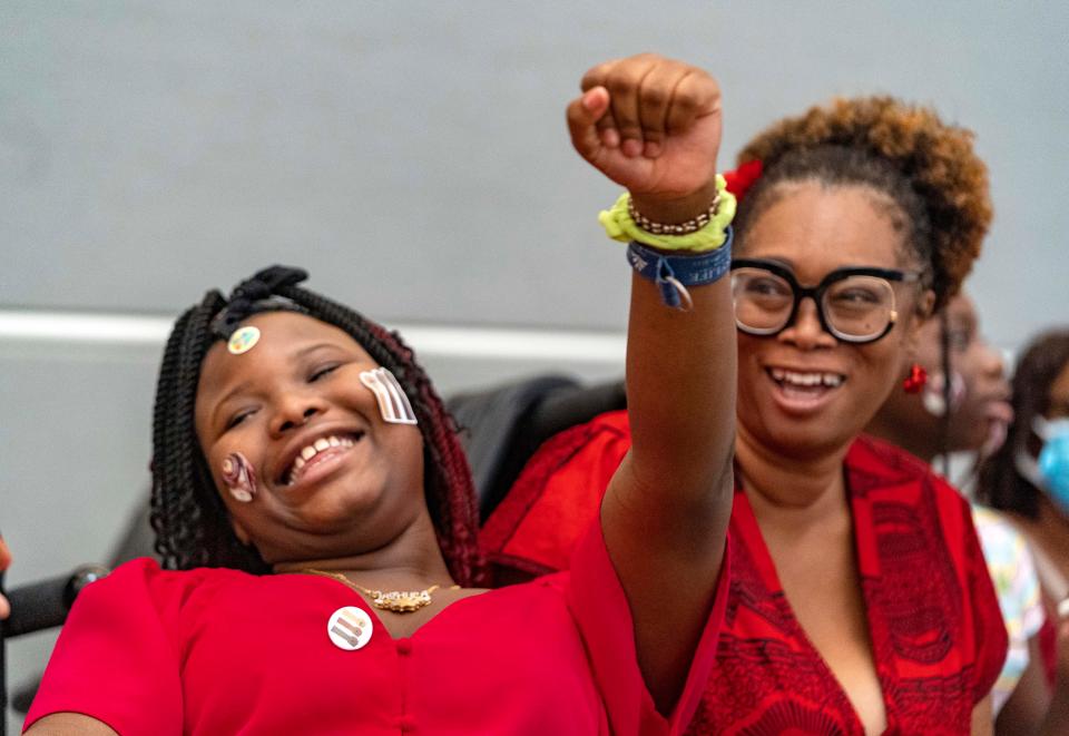 Jashyla Owens, left, and Shica Hardy enjoy the music at Juneteenth Community Day at the Norton Museum of Art on Saturday.