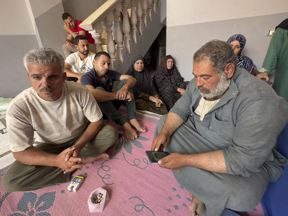 Saleh: Mohammed Saleh, the father of 18-year-old Yahia Saleh, holds a phone with a photo of his son at home in Ibrash, Egypt, Sunday, June 18, 2023. Yahia is one of dozens from the village feared to have drowned after a packed fishing vessel sank off Greece on June 14. There were as many as 750 migrants, including women and children, on board the trawler, which capsized and sank off Greece in one of the deepest parts of the Mediterranean Sea instead of docking in Italy. (AP Photo)