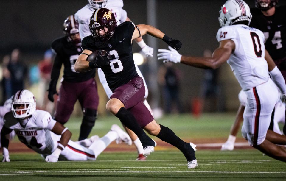 Dripping Springs wide receiver Nick Tyndall carries the ball through Lake Travis defense in the second quarter of the game, Oct. 20, 2023 in Dripping Springs.