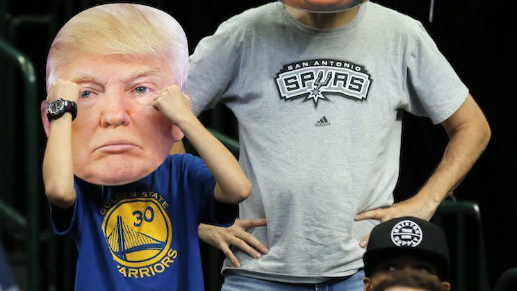 A Stephen Curry T-shirt-wearing NBA fan sported a Donald Trump mask at a game earlier this season. (AP)
