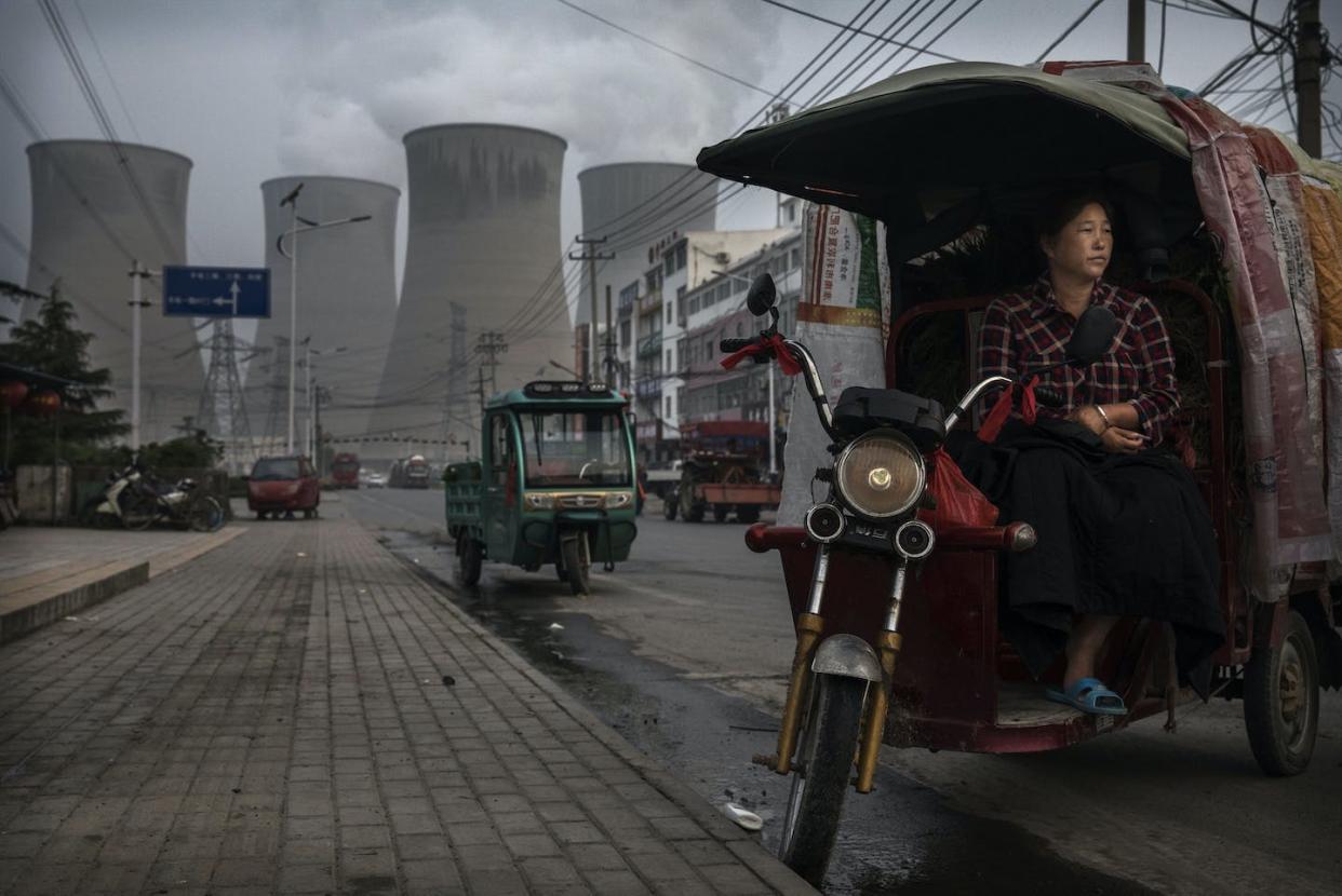 Fossil fuel emissions are still growing in much of the world. <a href="https://www.gettyimages.com/detail/news-photo/chinese-vendor-waits-for-customers-as-she-sells-vegetables-news-photo/800065690" rel="nofollow noopener" target="_blank" data-ylk="slk:Kevin Frayer/Getty Images;elm:context_link;itc:0;sec:content-canvas" class="link "> Kevin Frayer/Getty Images</a>