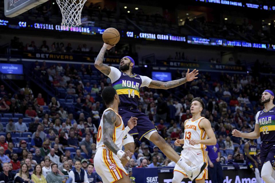 New Orleans Pelicans forward Brandon Ingram (14) shoots over Atlanta Hawks forward John Collins (20) in the first half of an NBA basketball game in New Orleans, Tuesday, Feb. 7, 2023. (AP Photo/Matthew Hinton)