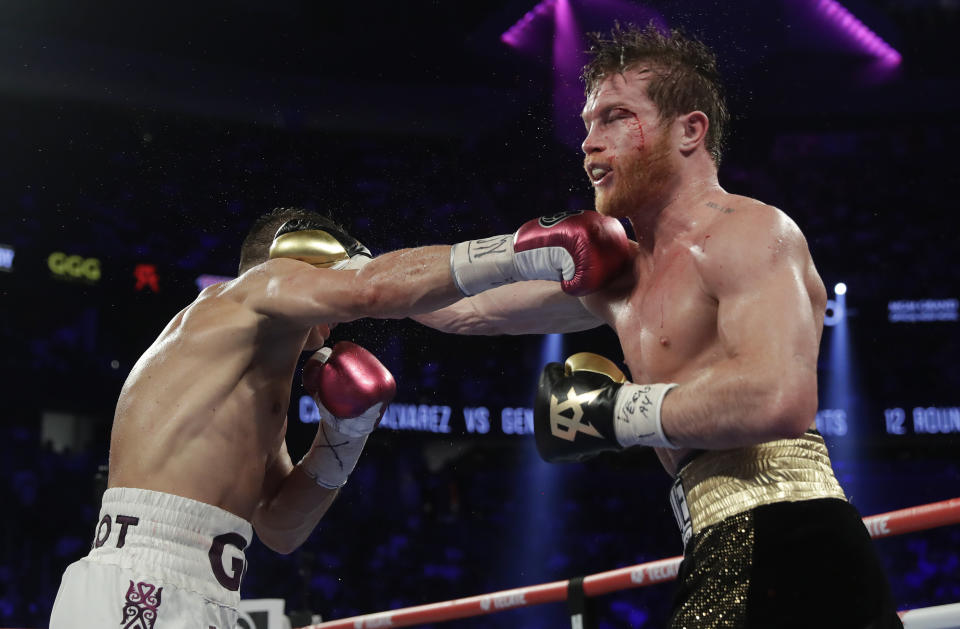 Canelo Alvarez, right, and Gennady Golovkin trade punches in the ninth round during a middleweight title boxing match, Saturday, Sept. 15, 2018, in Las Vegas. (AP Photo/Isaac Brekken)