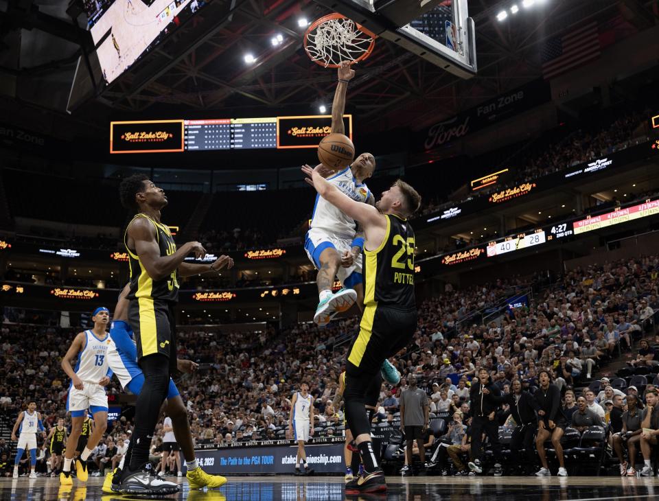 Oklahoma City’s Tre Mann dunks on Utah’s <a class="link " href="https://sports.yahoo.com/nba/players/6655" data-i13n="sec:content-canvas;subsec:anchor_text;elm:context_link" data-ylk="slk:Micah Potter;sec:content-canvas;subsec:anchor_text;elm:context_link;itc:0">Micah Potter</a> as the Jazz and Thunder play in Summer League action at the Delta Center in Salt Lake City on Monday, July 3, 2023. Oklahoma won 95-85. | Scott G Winterton, Deseret News