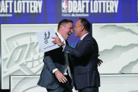 San Antonio Spurs managing partner Peter J. Holt, left, hugs NBA Deputy Commissioner Mark Tatum after Tatum announced that the Spurs had won the first pick in the NBA draft, during the draft lottery in Chicago, Tuesday, May 16, 2023. (AP Photo/Nam Y. Huh)