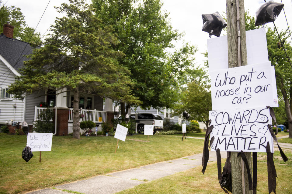 Regina and Donald Simon display signs in their yard in Saginaw on Monday, July 13, 2020. On Sunday, July Donald looked in his vehicle to find what appears to be a noose, with a note attached. A retired Michigan optometrist faces federal charges for allegedly leaving nooses and notes mocking the Black Lives Matter movement inside the mixed-race couple's pickup truck, near or inside several stores and placing threatening phone calls. (Kaytie Boomer/Saginaw News via AP)