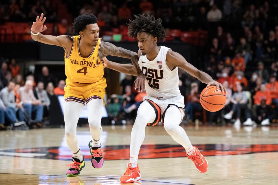 Oregon State forward Glenn Taylor Jr. (35) drives past Arizona State guard Desmond Cambridge Jr. (4) during the first half of an NCAA college basketball game in Corvallis, Ore., Saturday, Jan. 14, 2023. (AP Photo/Amanda Loman)