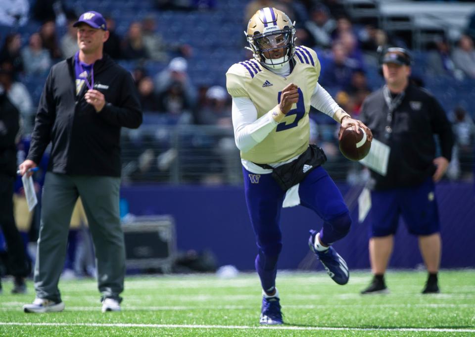 FILE - Washington quarterback Michael Penix Jr. carries the ball during a spring NCAA college football scrimmage, Saturday, April 30, 2022, in Seattle. Washington is set to kick off its season on Sept. 3, 2022, against Kent State. (Cheyenne Boone/The News Tribune via AP, File)