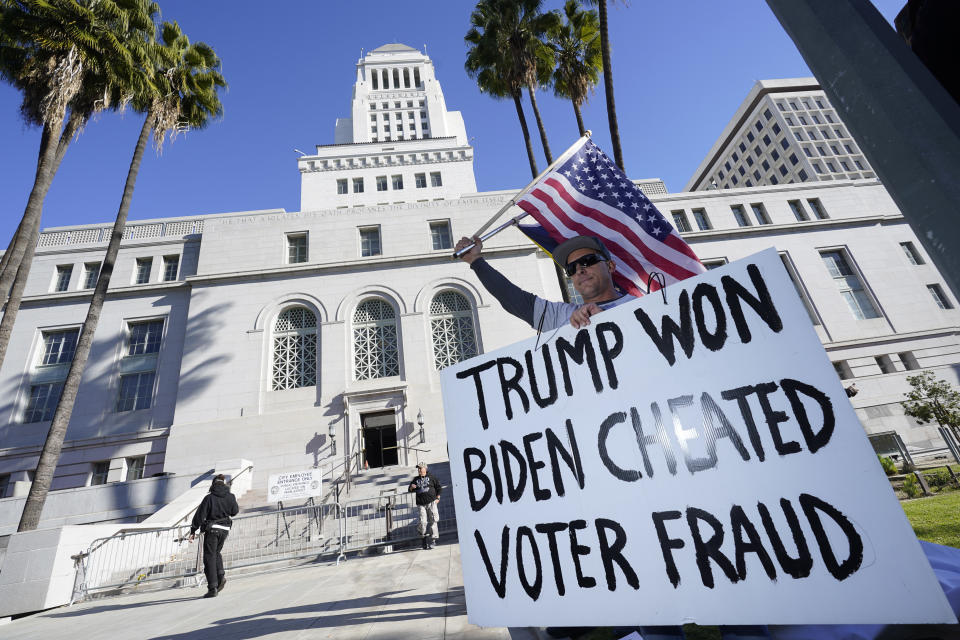 FILE - A protester holds a sign outside of City Hall Wednesday, Jan. 6, 2021, in Los Angeles. A state GOP rule change has opened the possibility that former President Donald Trump could sweep California’s entire trove of delegates in the March 5 primary, the plumpest prize in the party’s nominating contest. The election falls on Super Tuesday, when California is among more than a dozen states holding primaries and the largest number of delegates are up for grabs of any single day. (AP Photo/Marcio Jose Sanchez, File)