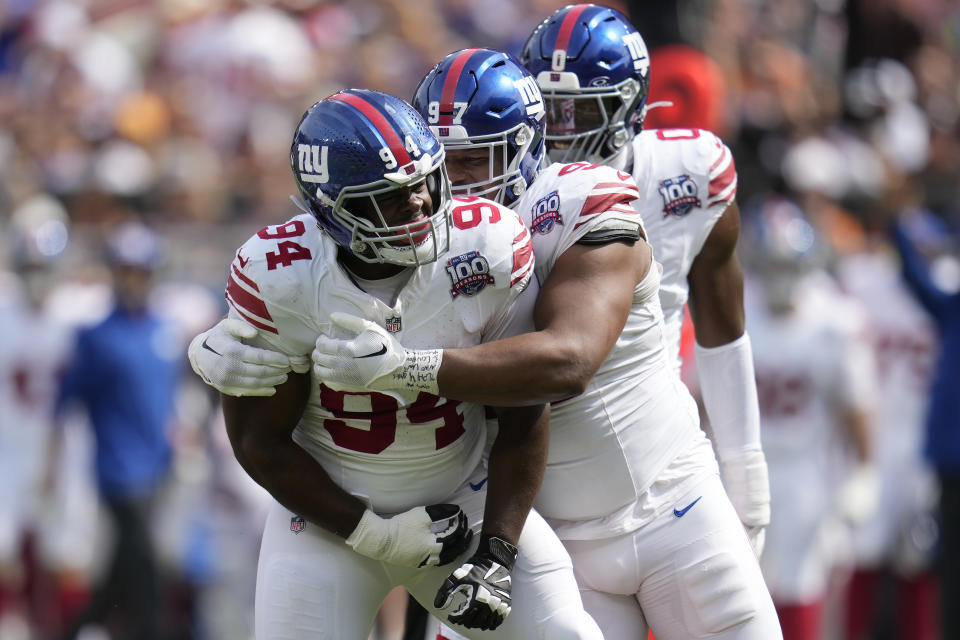 New York Giants defensive tackle Elijah Chatman (94) is congratulated by defensive tackle Dexter Lawrence II, middle, and linebacker Brian Burns after sacking Cleveland Browns quarterback Deshaun Watson during the first half of an NFL football game, Sunday, Sept. 22, 2024 in Cleveland. (AP Photo/Sue Ogrocki)