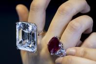 Displayed with the 100-carat diamond was "The Sunrise Ruby" (pictured on the right). The Cartier-mounted ring will go on sale in Geneva on May 12 and is expected to fetch between $12-$18M USD.(REUTERS/Tyrone Siu)