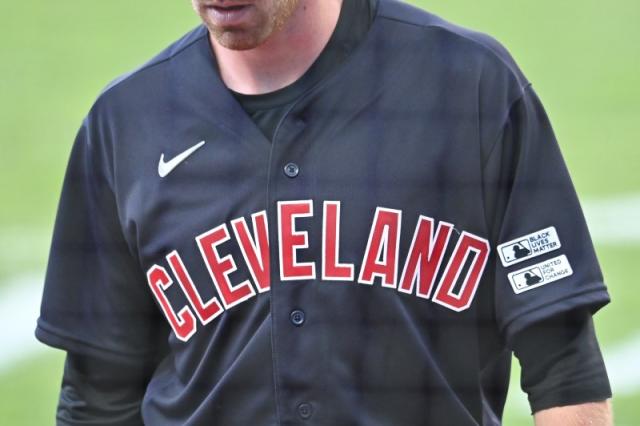 Indians wear road uniforms with 'Cleveland' on the chest on