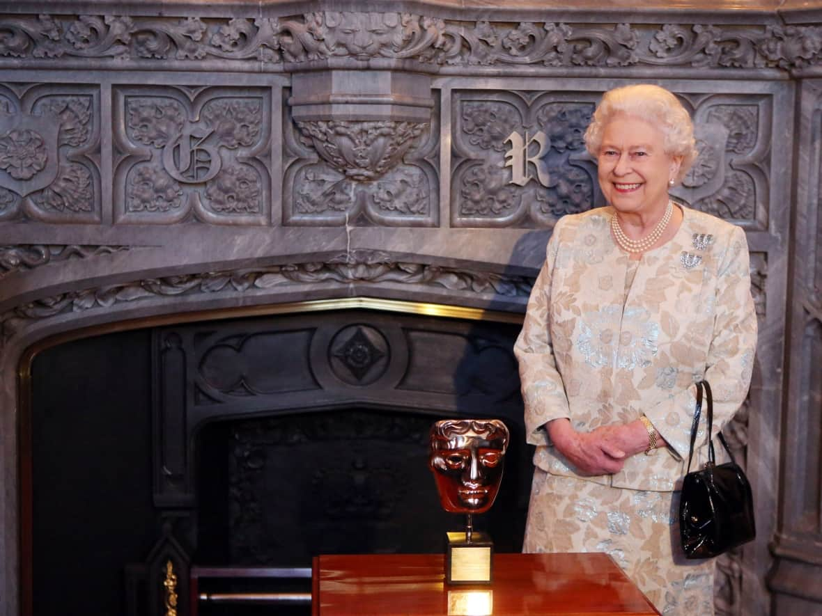 Queen Elizabeth received an honorary British Academy Film Award on April 4, 2013,  in recognition of her lifetime's support of British film and television — and for being the most 'memorable Bond girl yet' in her London Olympics opening role.   (Steve Parsons/The Associated Press - image credit)