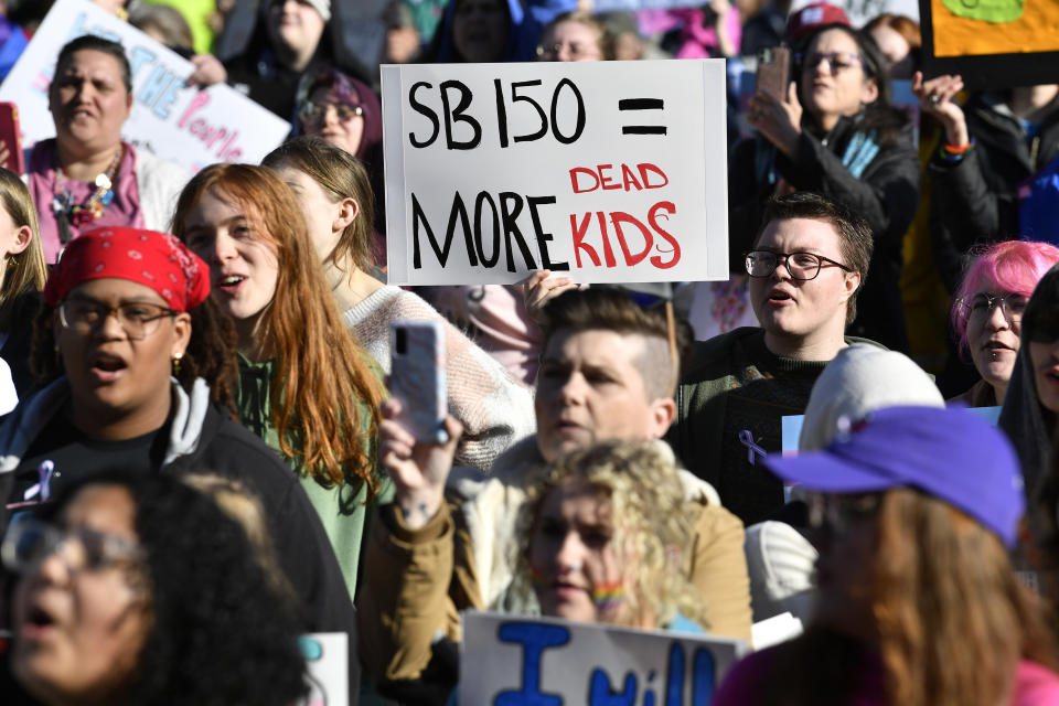 A protester holds up a sign showing her opinion of Kentucky Senate bill SB150, known as the Transgender Health Bill, during a rally on the lawn of the Kentucky State Capitol in Frankfort, Ky., Wednesday, March 29, 2023. (AP Photo/Timothy D. Easley)