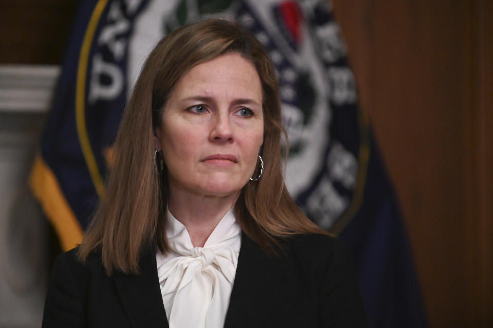 FILE - In this Oct. 1, 2020, file photo Supreme Court nominee Judge Amy Coney Barrett, meets with Sen. Joni Ernst, R-Iowa, at the Capitol in Washington. Hearings before the Republican-led Senate Judiciary Committee will begin Monday, Oct. 12, for Barrett. (Erin Scott/Pool via AP, File)