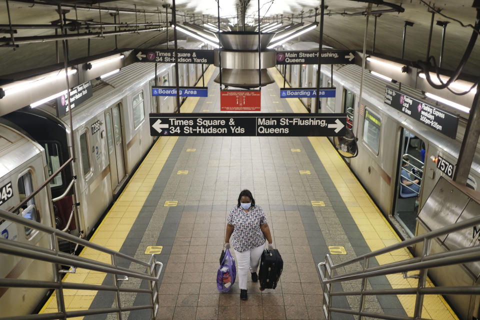 A commuters walks on a nearly empty subway platform in New York, Monday, June 8, 2020. The New York City immortalized in song and scene has been swapped out for the last few months with the virus version. In all the unknowing of what the future holds, there's faith in that other quintessential facet of New York City: that the city will adapt. (AP Photo/Seth Wenig)