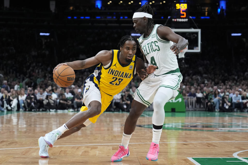 Indiana Pacers forward Aaron Nesmith (23) drives against Boston Celtics guard Jrue Holiday (4) during the second quarter of Game 1 of the NBA Eastern Conference basketball finals, Tuesday, May 21, 2024, in Boston. (AP Photo/Charles Krupa)