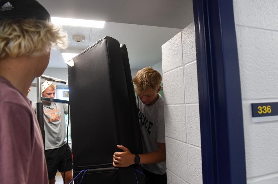 Tyler Plank, incoming sophomore, tackles moving a large futon into his dorm room on Saturday, August 27, 2022, at Augustana University in Sioux Falls.