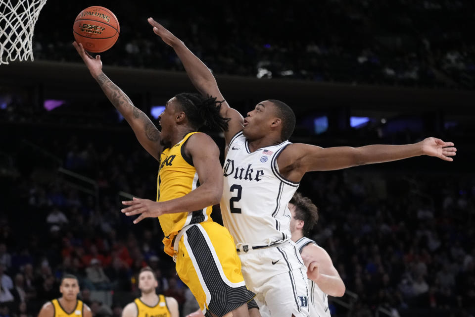 Iowa's Ahron Ulis (1) shoots against Duke's Jaylen Blakes (2) during the second half of an NCAA college basketball game in the Jimmy V Classic, Tuesday, Dec. 6, 2022, in New York. (AP Photo/John Minchillo)