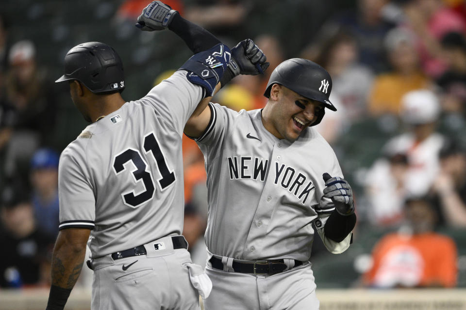 New York Yankees' Jose Trevino, right, celebrates his three-run home run with teammate Aaron Hicks (31) during the fourth inning of a baseball game against the Baltimore Orioles, Monday, May 16, 2022, in Baltimore. (AP Photo/Nick Wass)