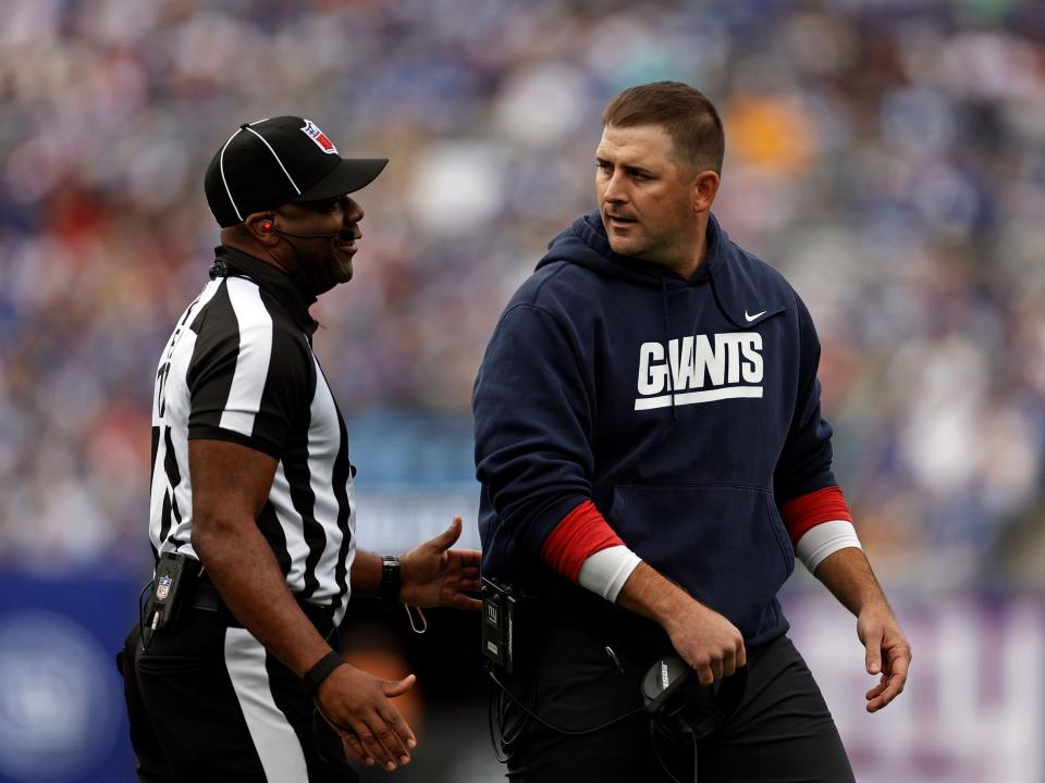 Joe Judge speaks with an official during a game against the Los Angeles Rams.