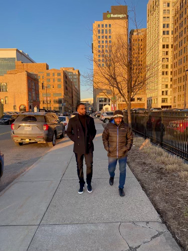 Aphid CEO Brandon Cooper, at left, cofounded the AI company with Shri Ramani. They have since launched a Motor City office. Here they walk in Detroit in March 2024.