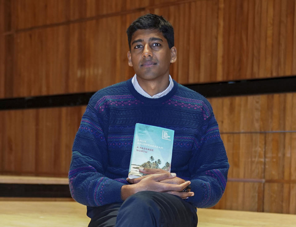 Anuk Arudpragasam with his book A Passage North, one of the six authors shortlisted for the 2021 Booker Prize, during a photo call at the Royal Festival Hall in London, Sunday Oct. 31, 2021. (Kirsty O'Connor/PA via AP)
